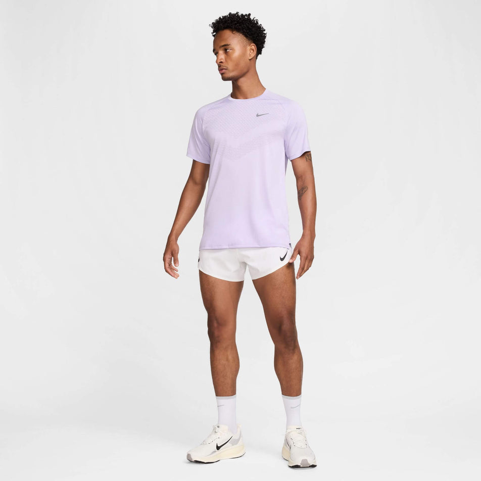 Front view of a model wearing the Nike Men's Stride Dri-FIT ADV Short-Sleeve Running Top in the Hydrangeas/Reflective Silv colourway. Model is also wearing shorts, socks and shoes. (8620701089954)