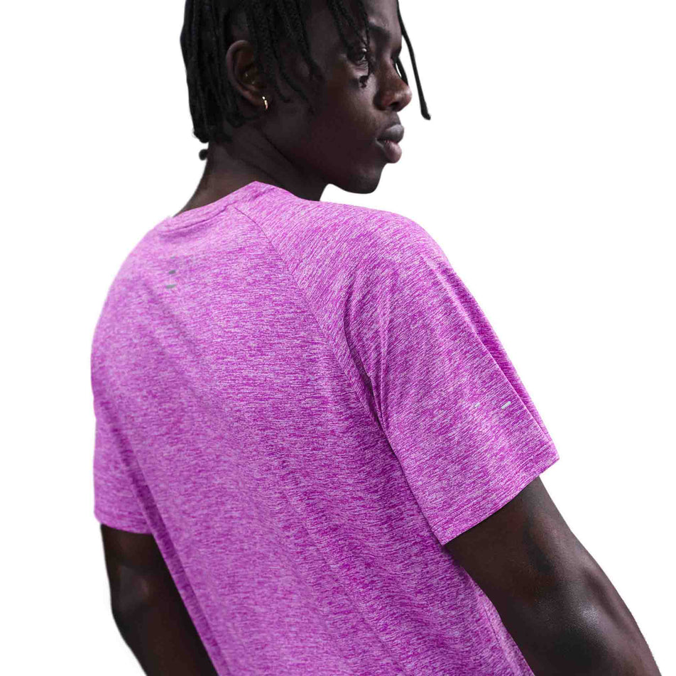 Back view of a model wearing the Nike Men's Stride Dri-FIT ADV Short-Sleeve Running Top in the Vivid Purple/Heather/Reflective Silver colourway. (8733245046946)