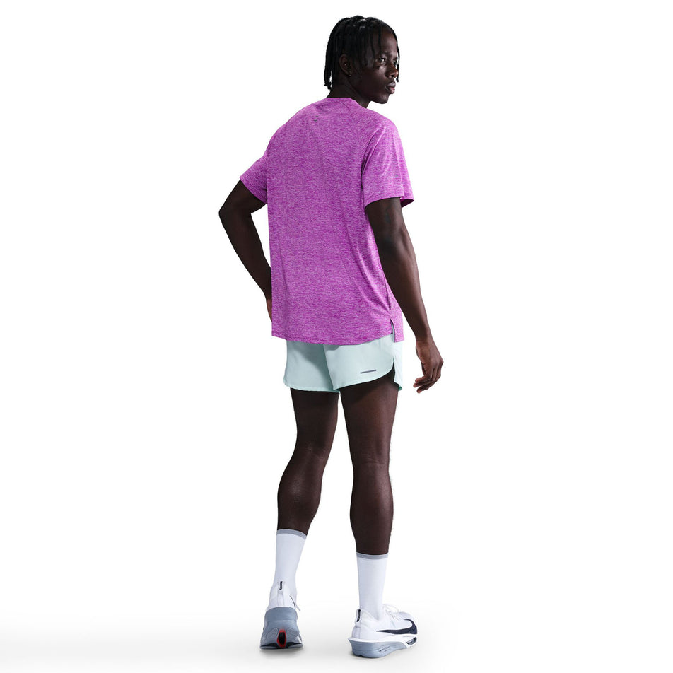 Back view of a model wearing the Nike Men's Stride Dri-FIT ADV Short-Sleeve Running Top in the Vivid Purple/Heather/Reflective Silver colourway. (8733245046946)