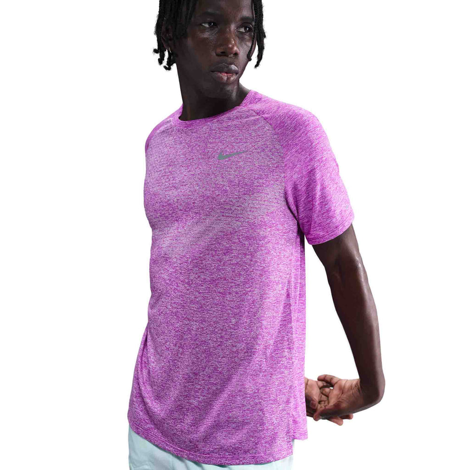 Front view of a model wearing the Nike Men's Stride Dri-FIT ADV Short-Sleeve Running Top in the Vivid Purple/Heather/Reflective Silver colourway. (8733245046946)