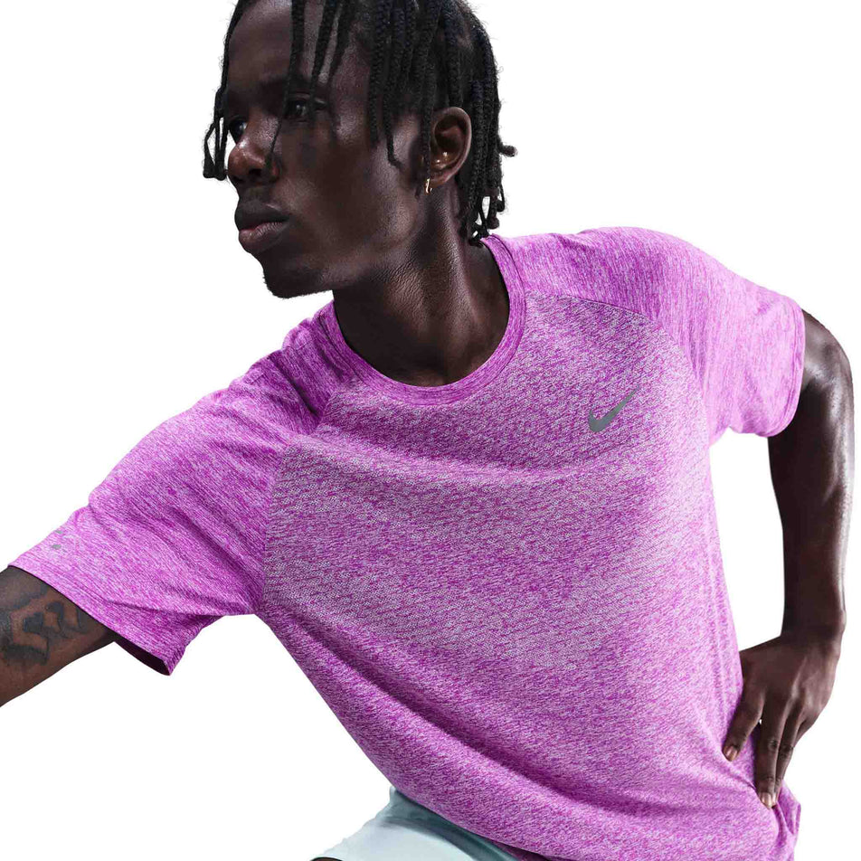 Front view of a model wearing the Nike Men's Stride Dri-FIT ADV Short-Sleeve Running Top in the Vivid Purple/Heather/Reflective Silver colourway. (8733245046946)