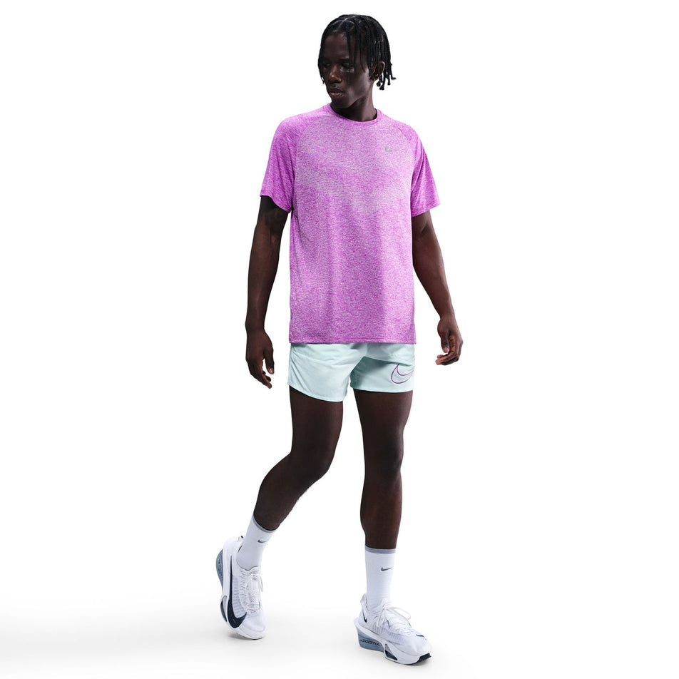 Front view of a model wearing the Nike Men's Stride Dri-FIT ADV Short-Sleeve Running Top in the Vivid Purple/Heather/Reflective Silver colourway. (8733245046946)