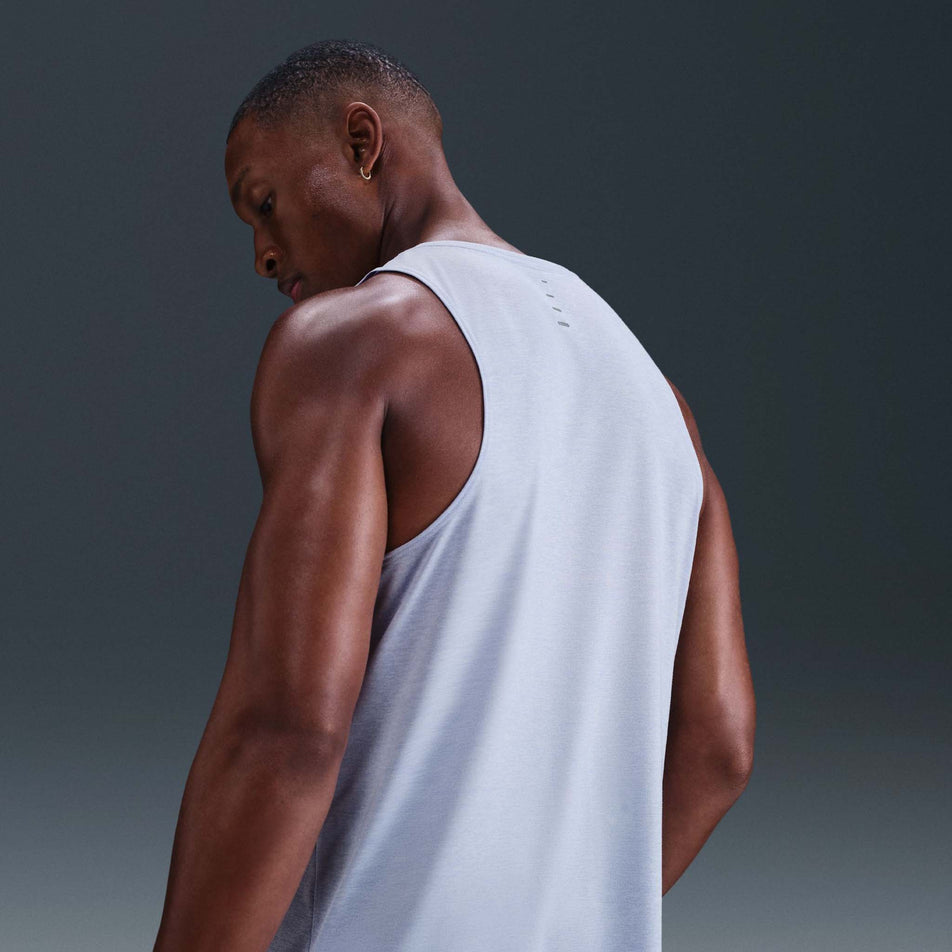 Back view of a model wearing the Nike Men's Stride Dri-FIT ADV Running Tank Top in the Ghost/Heather/Reflective Silver colourway. (8710807388322)