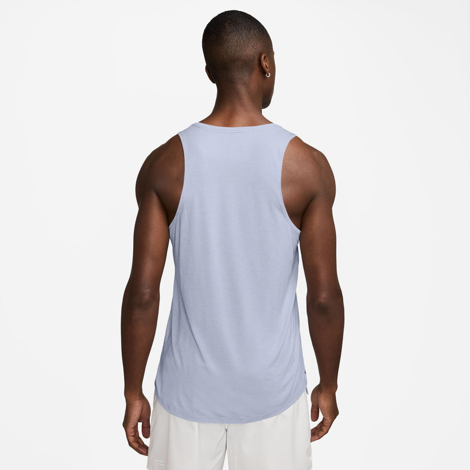 Back view of a model wearing the Nike Men's Stride Dri-FIT ADV Running Tank Top in the Ghost/Heather/Reflective Silver colourway. (8710807388322)