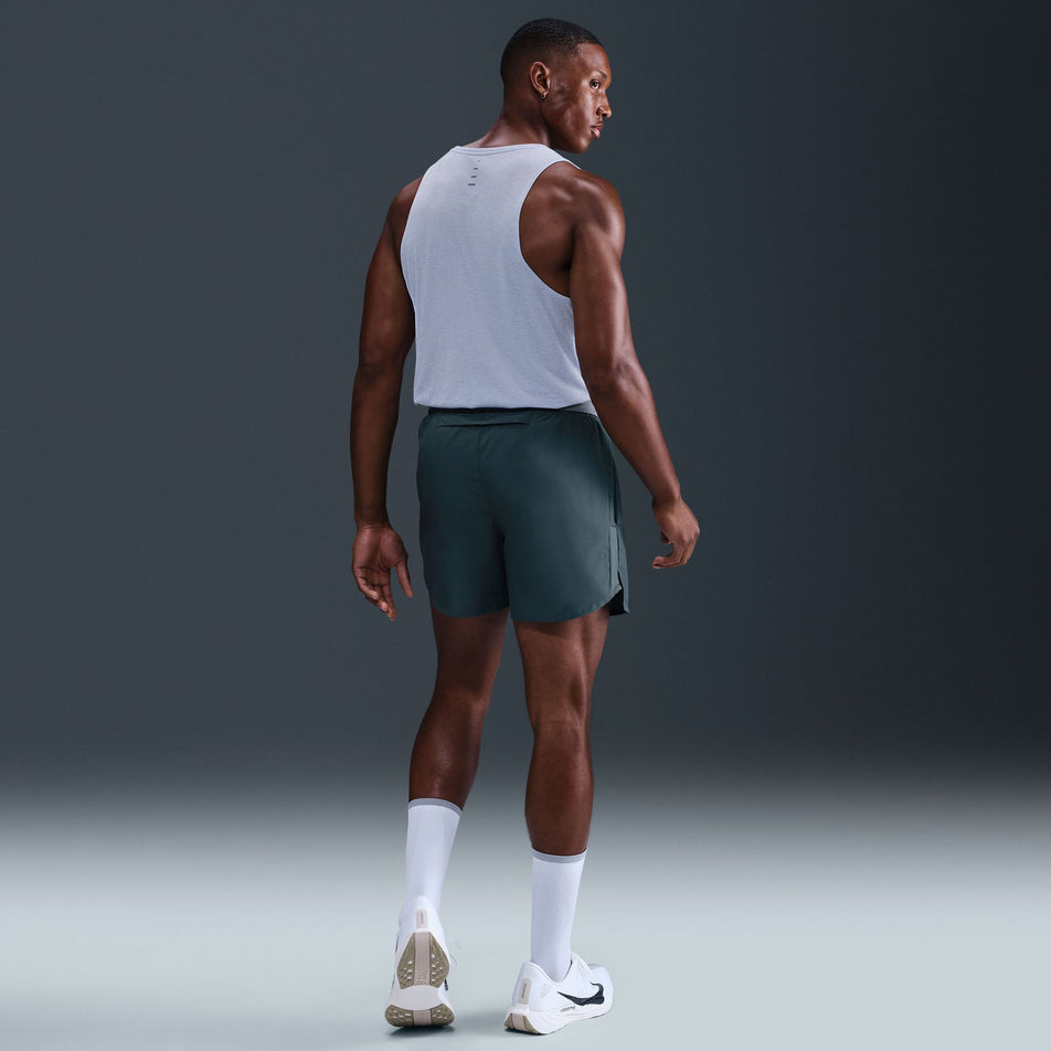 Back view of a model wearing the Nike Men's Stride Dri-FIT ADV Running Tank Top in the Ghost/Heather/Reflective Silver colourway. (8710807388322)