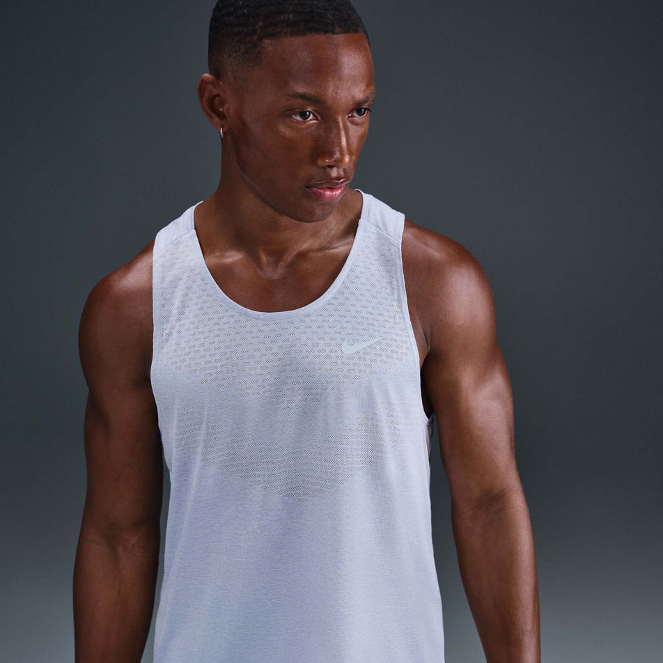 Front view of a model wearing the Nike Men's Stride Dri-FIT ADV Running Tank Top in the Ghost/Heather/Reflective Silver colourway. (8710807388322)