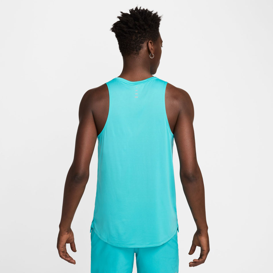 Back view of a model wearing a Nike Men's Stride Dri-FIT ADV Running Tank Top in the Dusty Cactus/Reflective Silver colourway. (8563458703522)