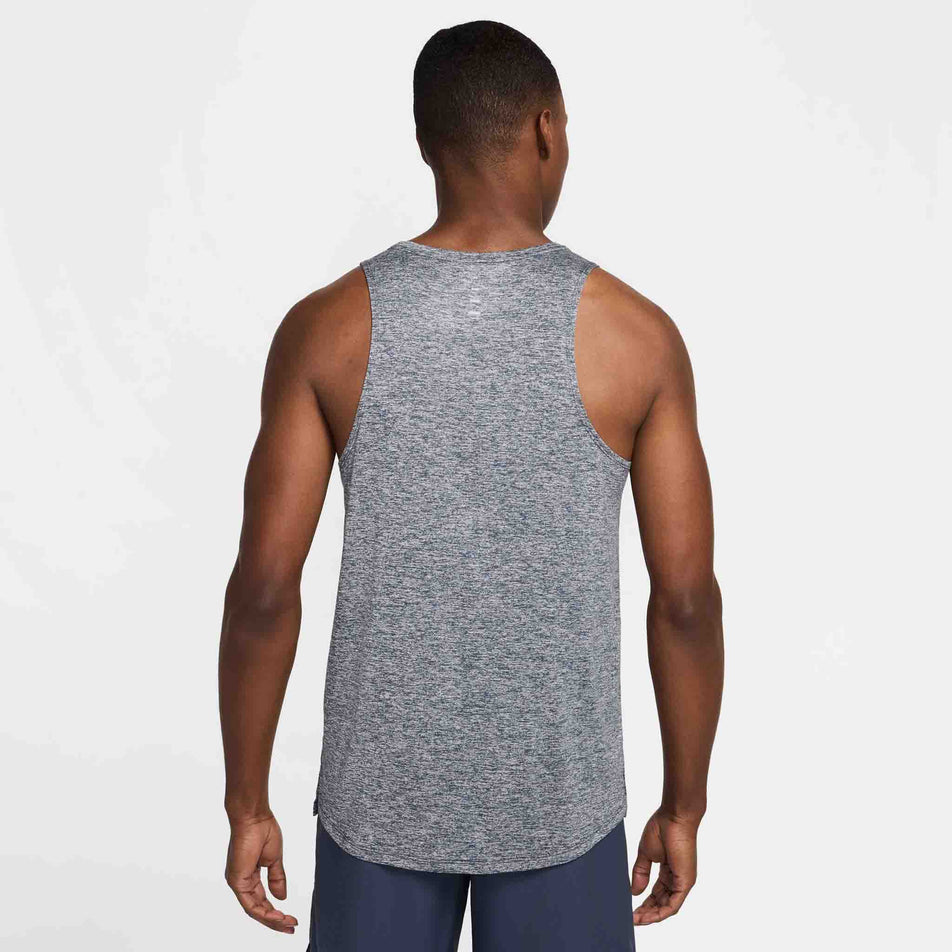 Back view of a model wearing the Nike Men's Stride Dri-FIT ADV Running Tank Top in the Thunder Blue/Heather/Reflective Silver colourway. (8620703940770)
