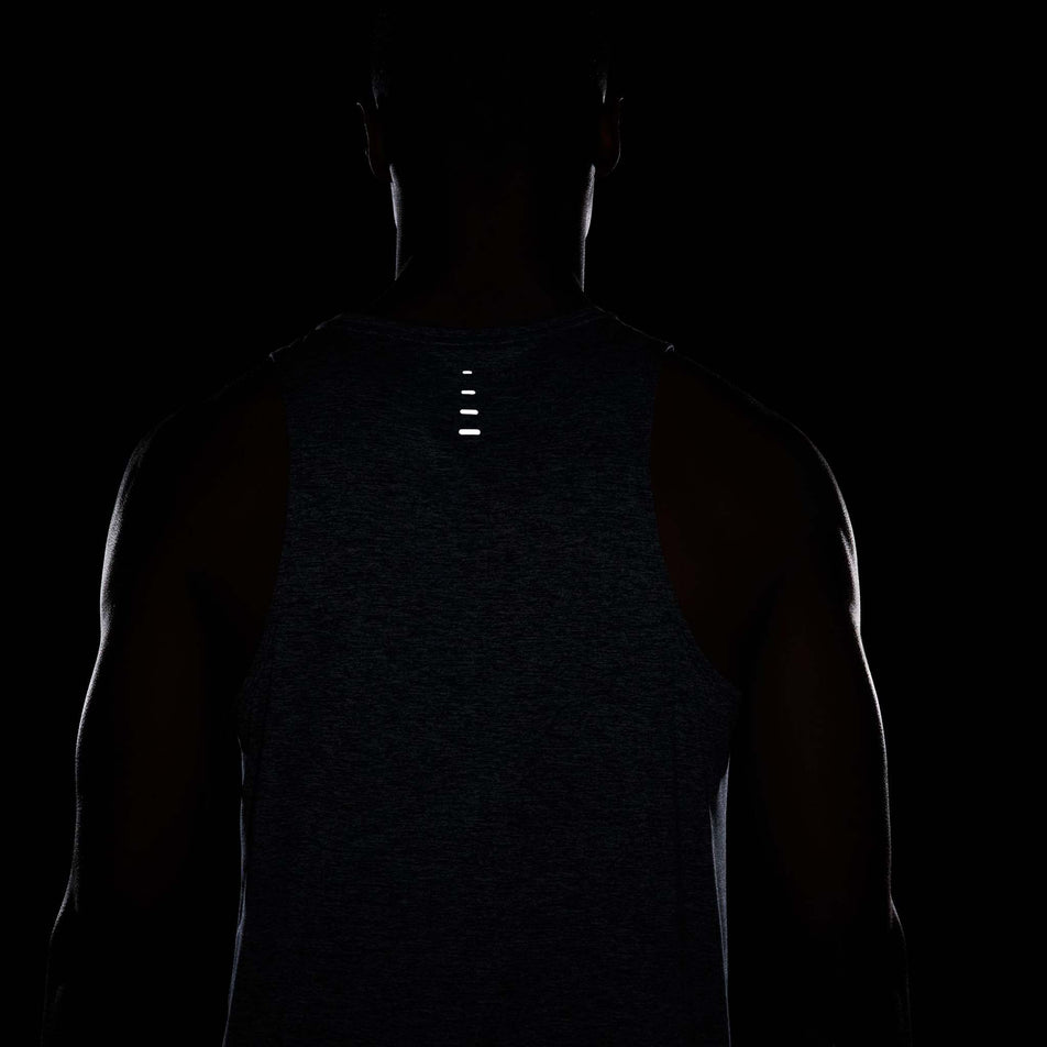 The reflective graphics on the back of the Nike Men's Stride Dri-FIT ADV Running Tank Top in the Thunder Blue/Heather/Reflective Silver colourway. (8620703940770)