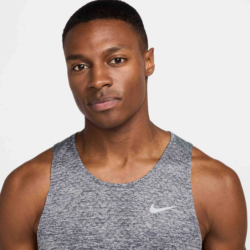 Front view of a model wearing the Nike Men's Stride Dri-FIT ADV Running Tank Top in the Thunder Blue/Heather/Reflective Silver colourway. (8620703940770)