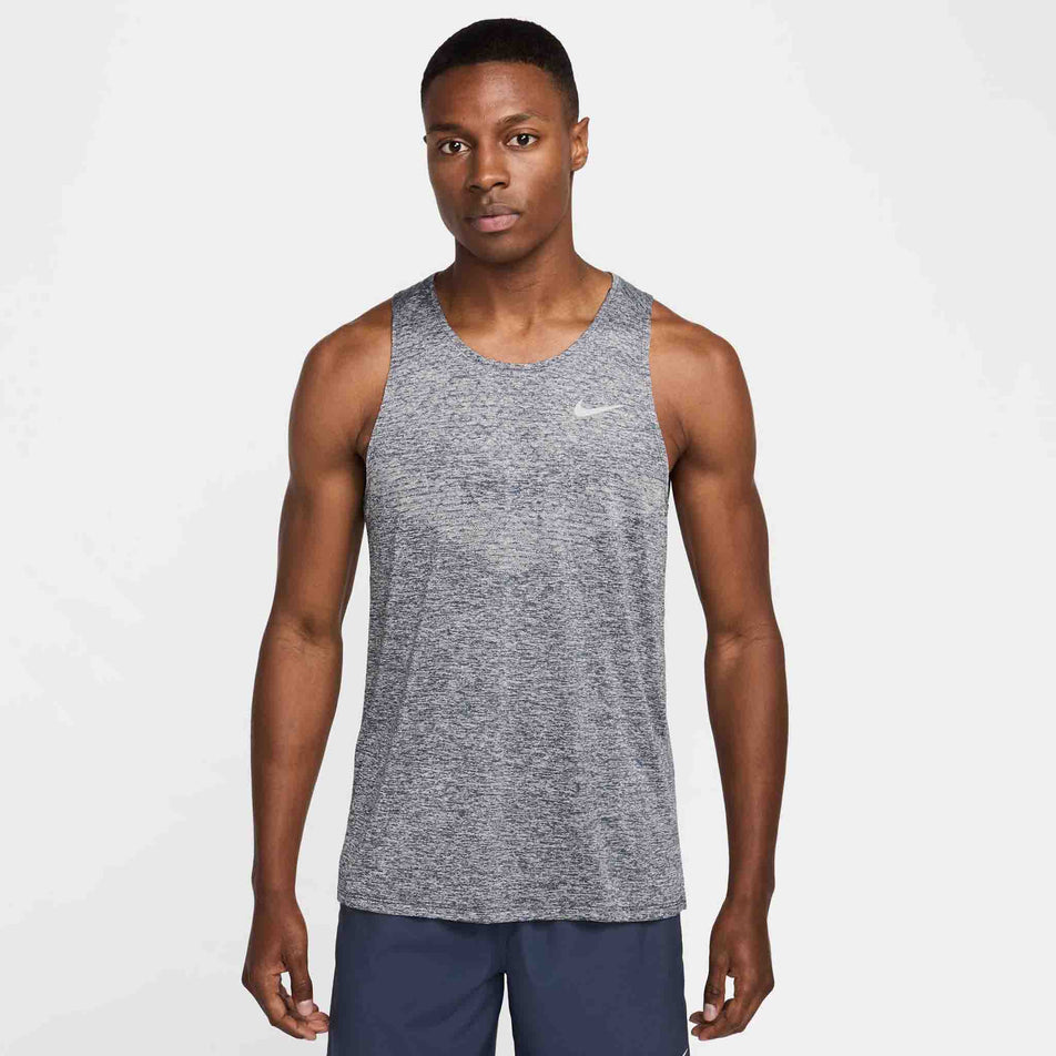 Front view of a model wearing the Nike Men's Stride Dri-FIT ADV Running Tank Top in the Thunder Blue/Heather/Reflective Silver colourway. (8620703940770)