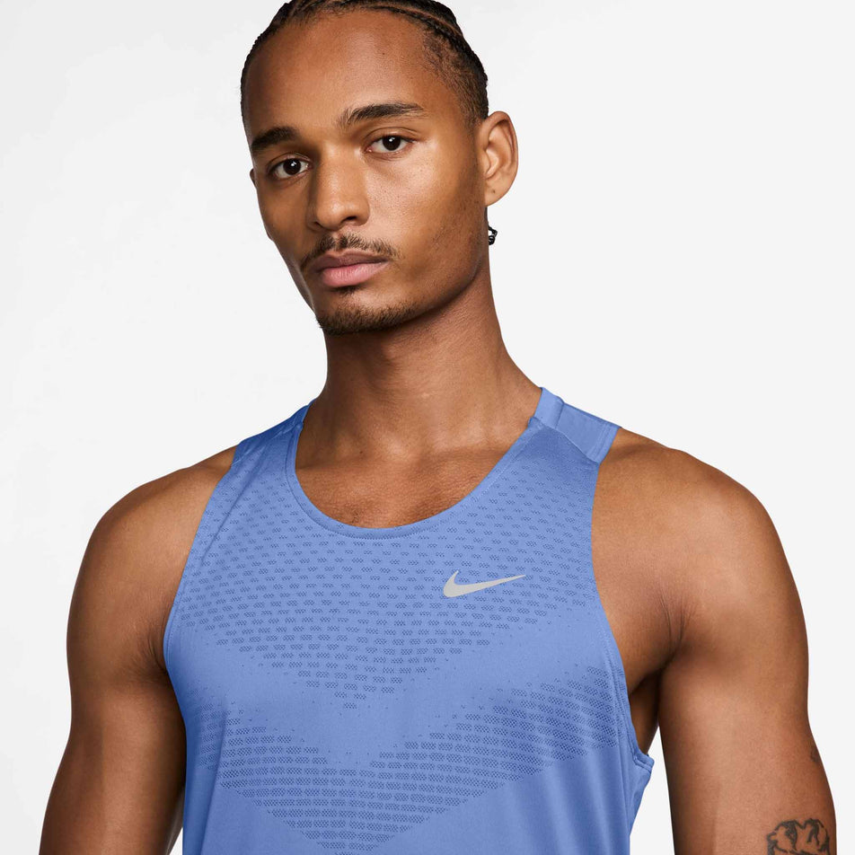 Front view of a model wearing the Nike Men's Stride Dri-FIT ADV Running Tank Top in the Royal Pulse/Reflective Silver colourway.