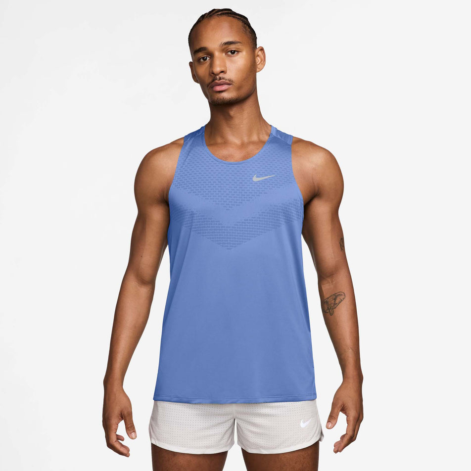 Front view of a model wearing the Nike Men's Stride Dri-FIT ADV Running Tank Top in the Royal Pulse/Reflective Silver colourway.