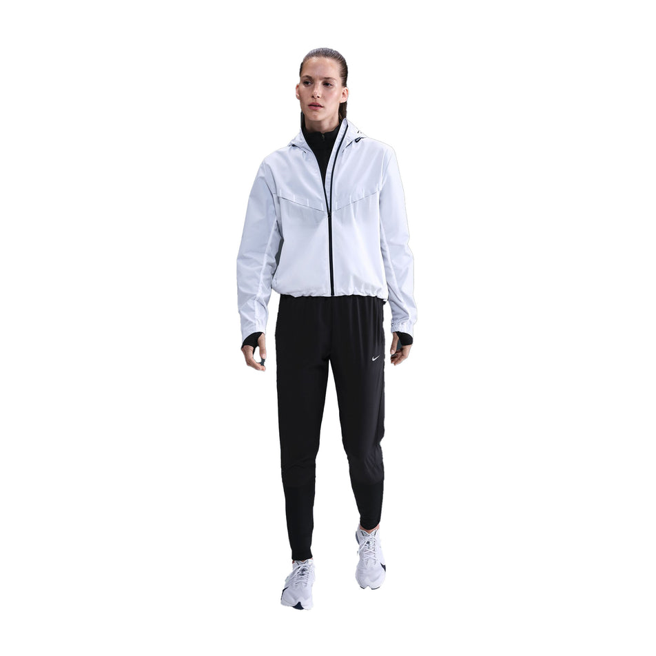 Front view of a model wearing the Nike Women's Dri-FIT Mid-Rise Running Pants in the Black/Reflective Silver colourway. (8732466151586)