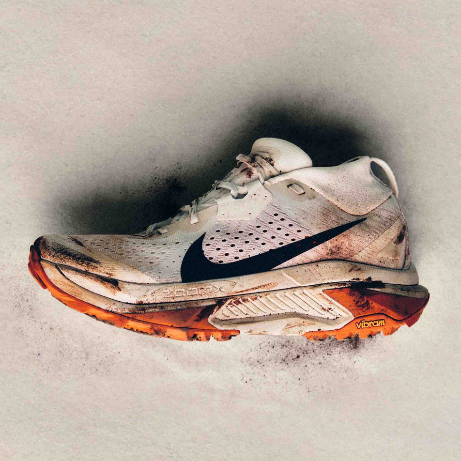 Lateral view of the left shoe from a pair of Nike Men's ACG Zegama Trail Running Shoes in the Summit White/Black-Phantom-Safety Orange colourway.