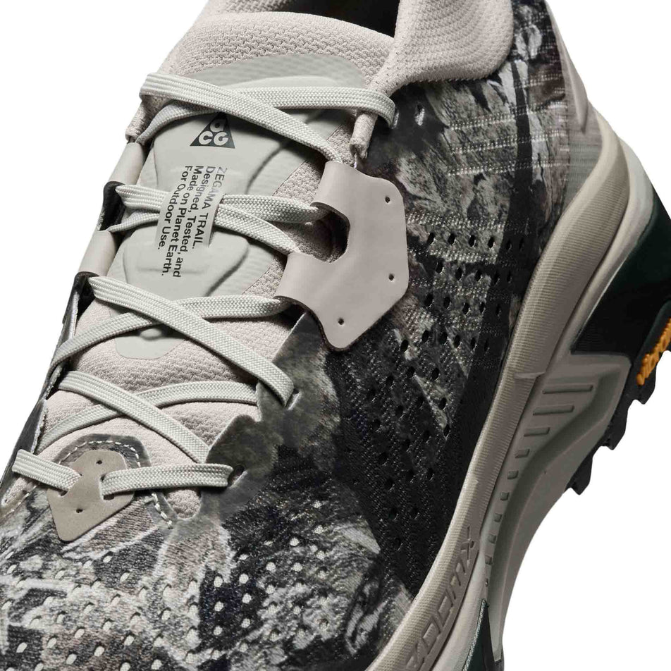 Close-up view of the upper of the left shoe from a pair of Nike Men's ACG Zegama Trail Running Shoes in the Spruce Fog/Black Spruce-Sea Glass-Black colourway.