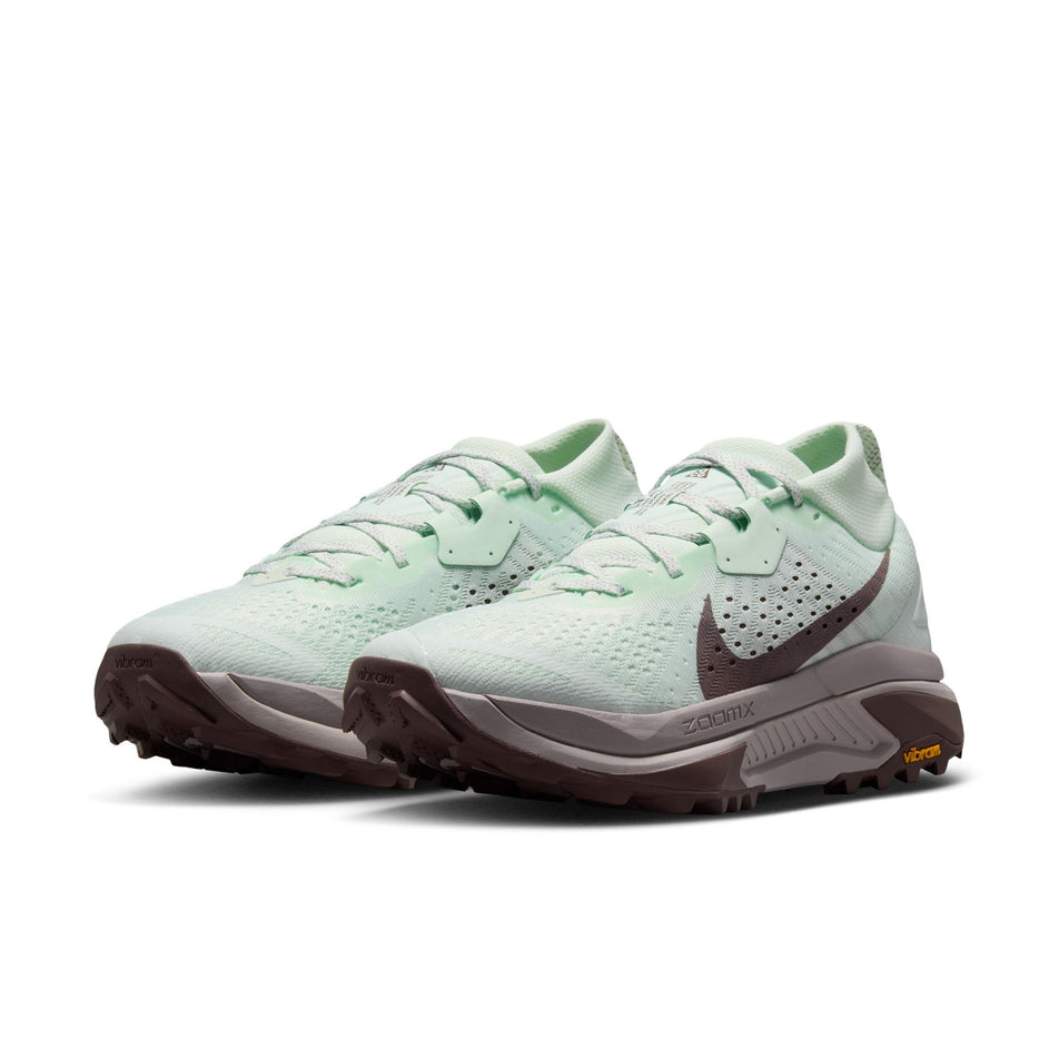 A pair of Nike Women's ACG Zegama Trail Running Shoes in the Barely Green/Silver Lilac-Tattoo colourway.