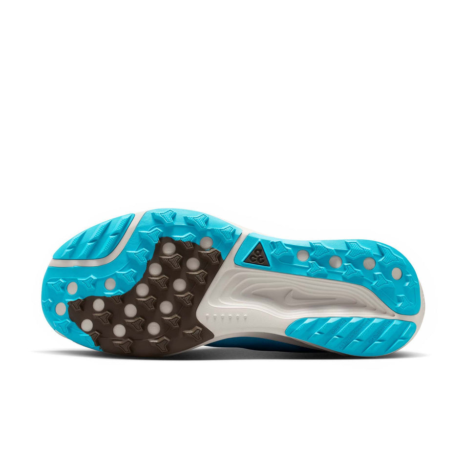 The outsole of the left shoe from a pair of Nike Men's ACG Pegasus Trail Running Shoes in the Baltic Blue/Summit White-Light Orewood Brown colourway.