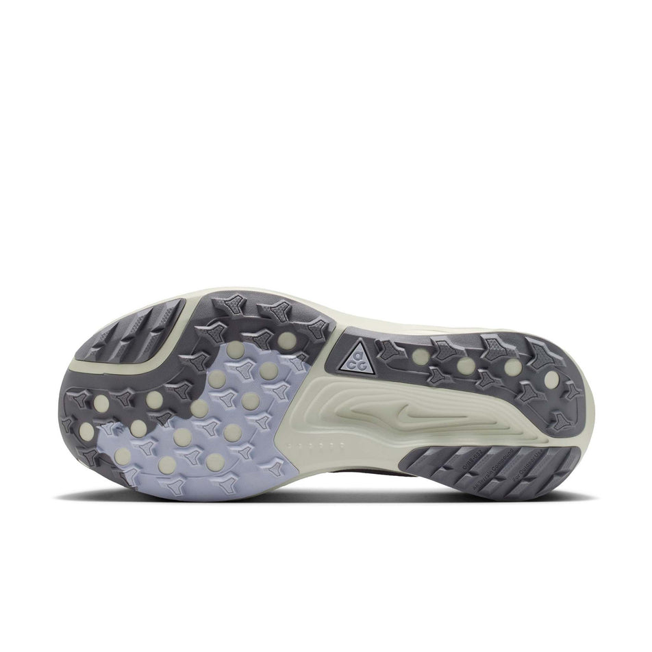 The outsole of the left shoe from a pair of Nike Women's ACG Pegasus Trail Running Shoes in the Ghost/Cement Grey-Mineral Slate colourway.