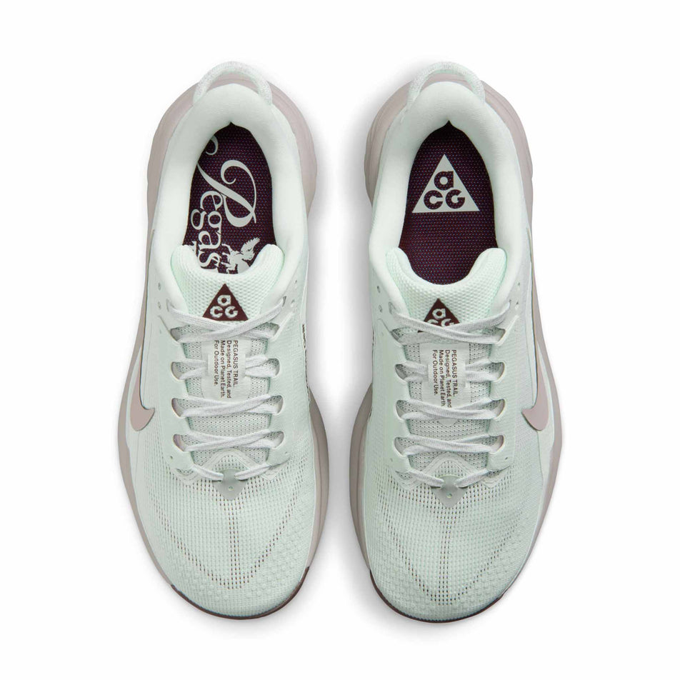 The uppers of a pair of Nike Women's ACG Pegasus Trail Running Shoes in the Barely Green/Silver Lilac-Light Bone colourway.