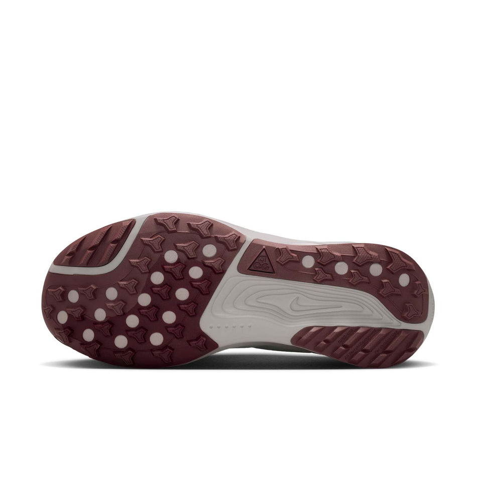 The outsole of the left shoe from a pair of Nike Women's ACG Pegasus Trail Running Shoes in the Barely Green/Silver Lilac-Light Bone colourway.