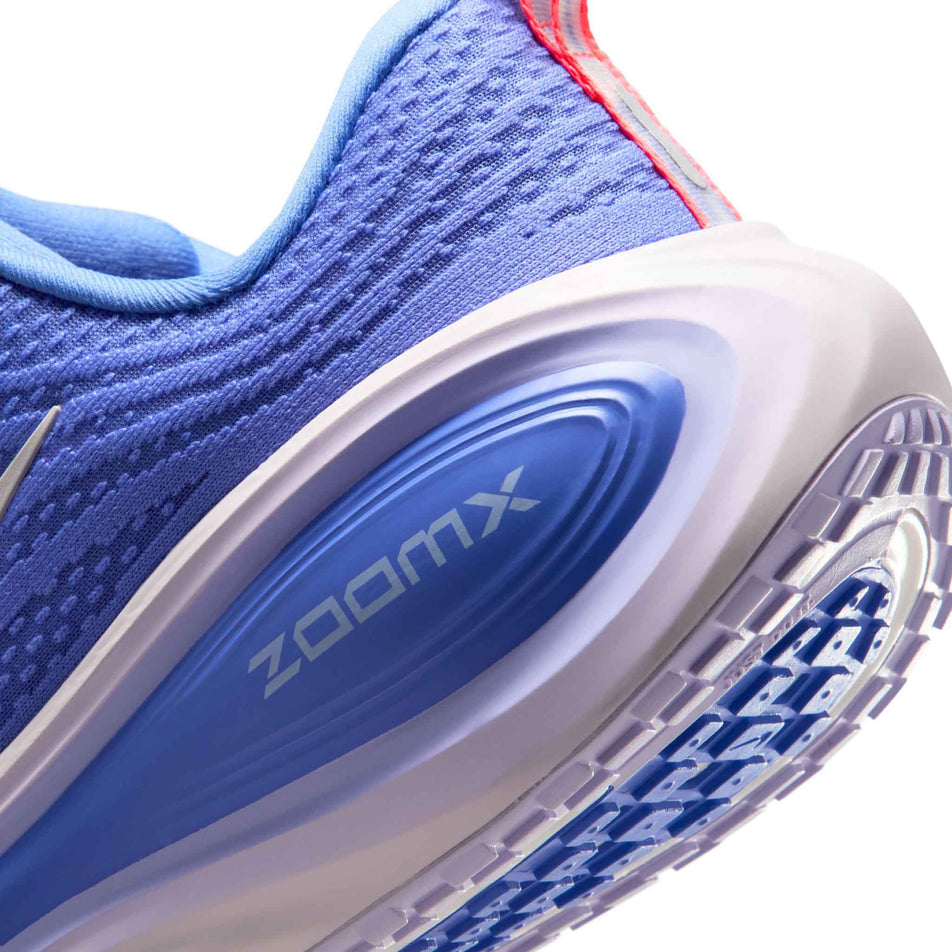 Close-up view of the rearfoot section of the left shoe from a pair of Nike Women's Vomero Plus Road Running Shoes in the Sapphire/Light Violet-Violet Mist colourway.