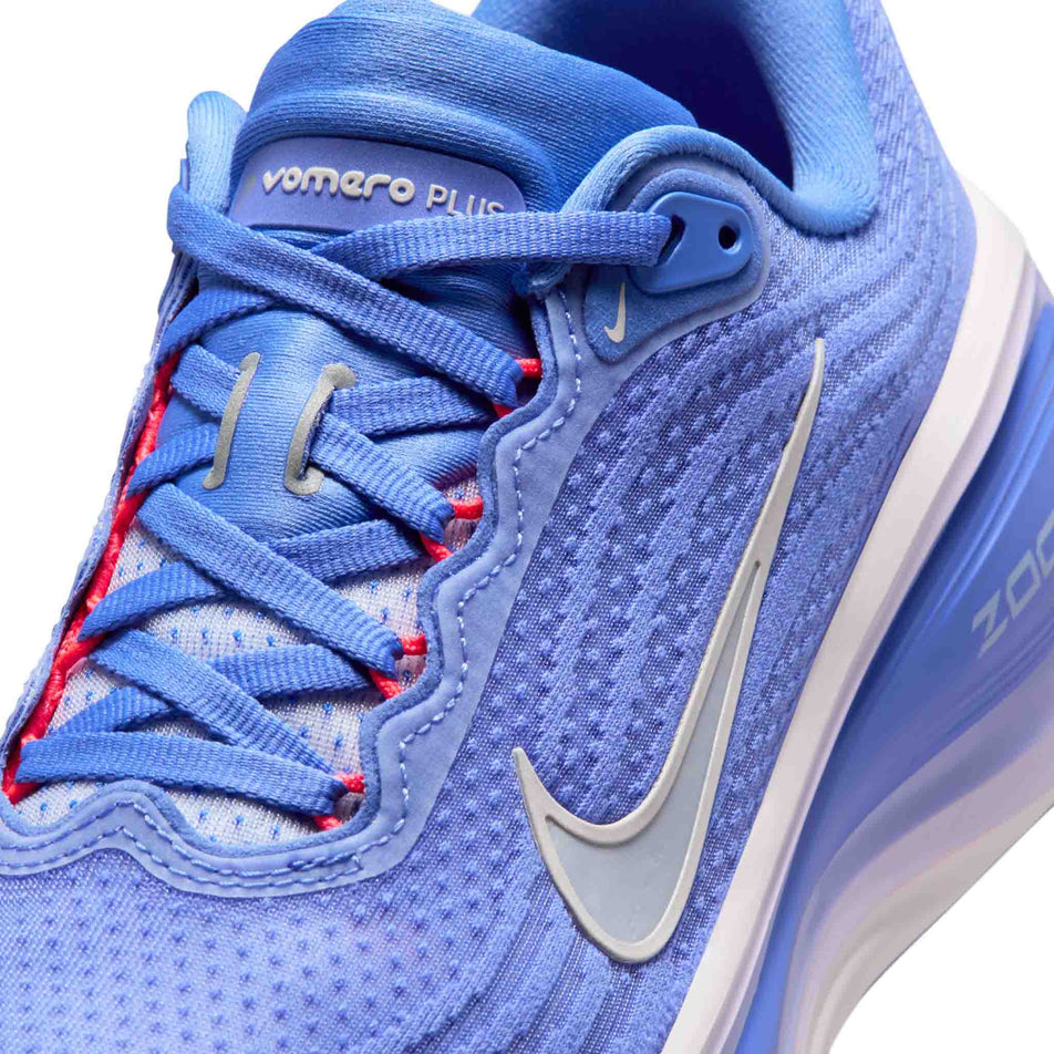 Close-up view of the upper of the lef shoe from a pair of Nike Women's Vomero Plus Road Running Shoes in the Sapphire/Light Violet-Violet Mist colourway.