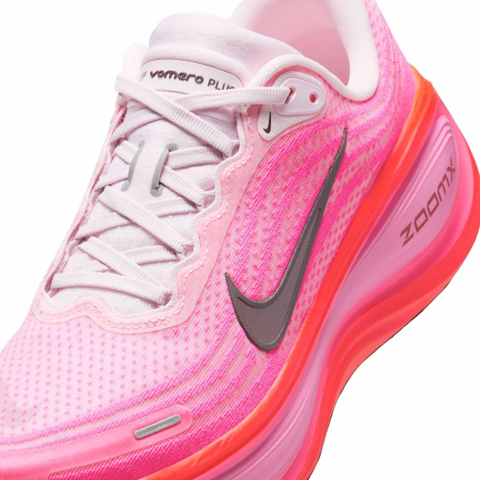 Close-up view of the upper of the left shoe from a pair of Nike Women's Vomero Plus Road Running Shoes in the Hyper Pink/Burgundy Crush colourway. (8736251773090)