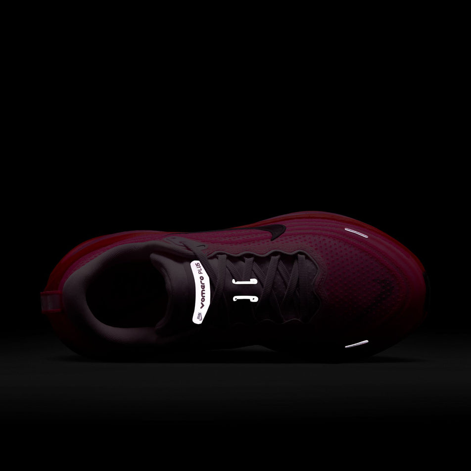 The reflective details on the upper of the Nike Women's Vomero Plus Road Running Shoes in the Hyper Pink/Burgundy Crush colourway. (8736251773090)