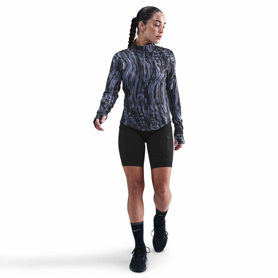 Front view of a model wearing the Nike Women's Swift Dri-FIT UV 1/2-Zip Printed Running Top in the World Indigo/Reflective Silver colourway. (8782446231714)