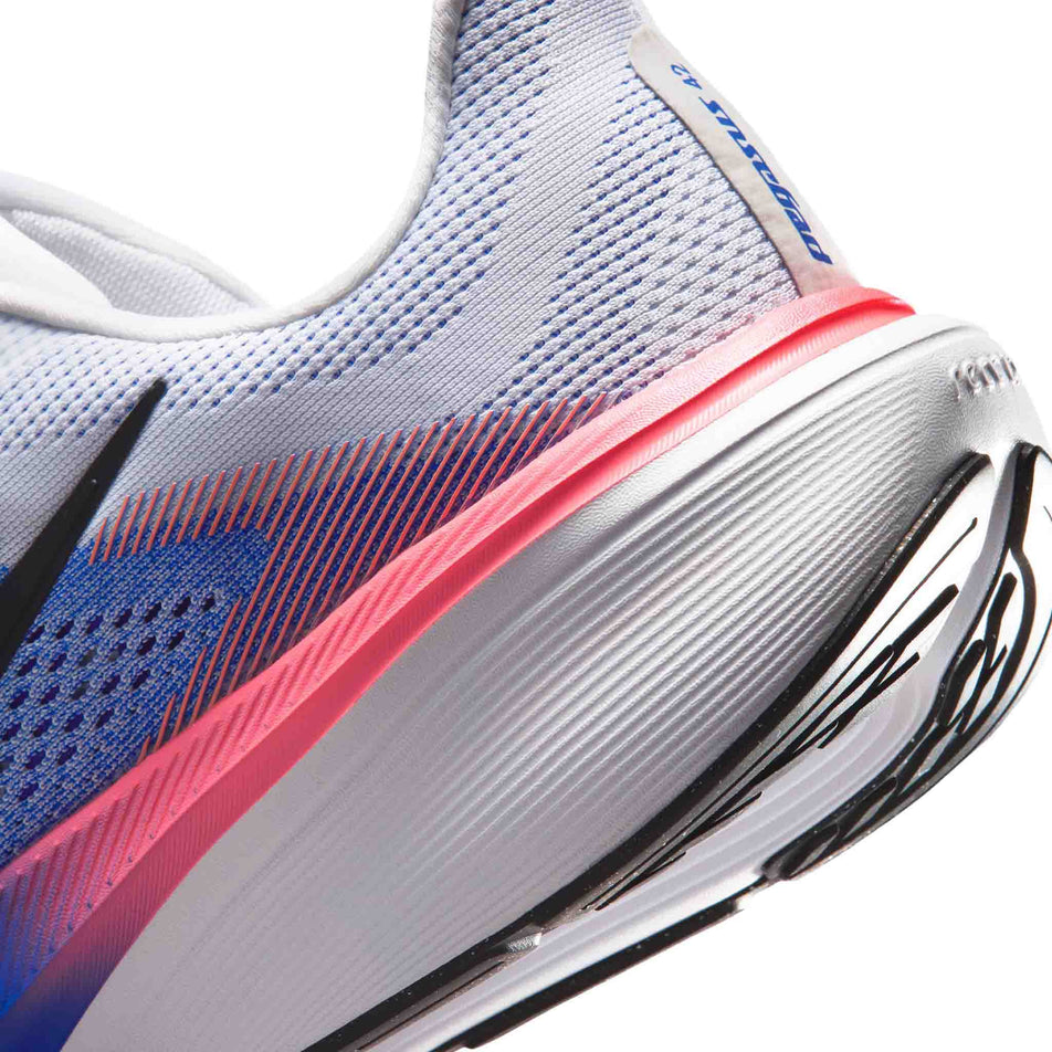 Close-up view of the rearfoot section of the left shoe from a pair of Nike Men's Pegasus 42 Road Running Shoes in the White/Black-Racer Blue-Atomic Pink colourway.