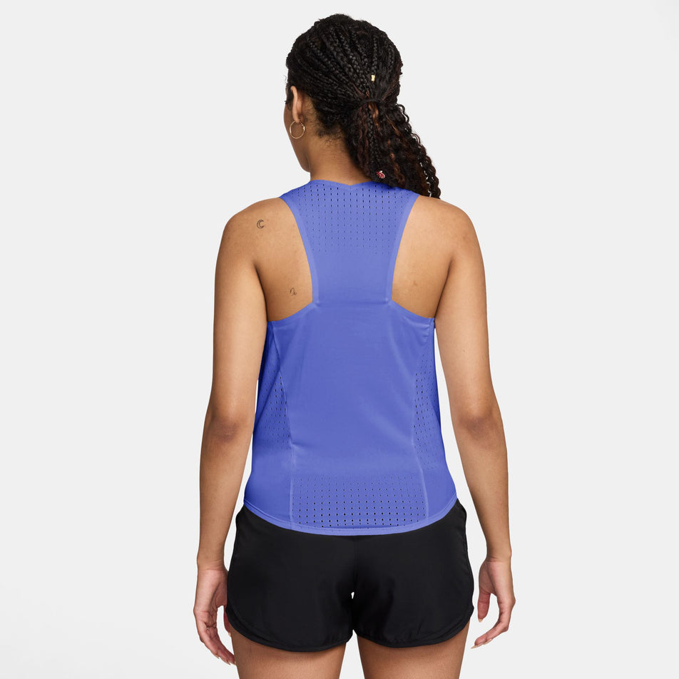 Back view of a model wearing the Nike Women's AeroSwift Dri-FIT ADV Running Singlet in the Sapphire/Black colourway.