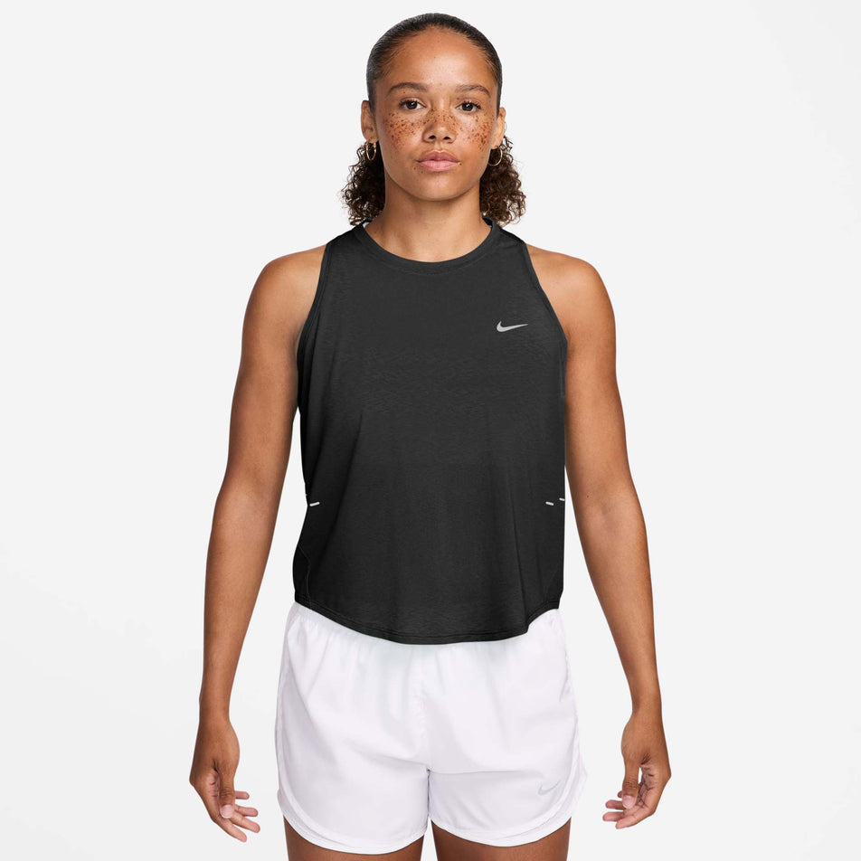 Front view of a model wearing the Nike Women's Swift Breathe Dri-FIT Running Tank Top in the Black/Black/White/Reflective Silver colourway.