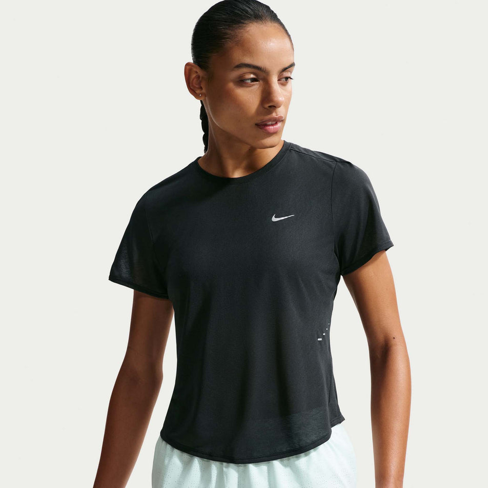 Front view of a model wearing the Nike Women's Swift Breathe Dri-FIT Short-Sleeve Running Top in the Black/Photon Dust/White/Reflective Silver colourway.