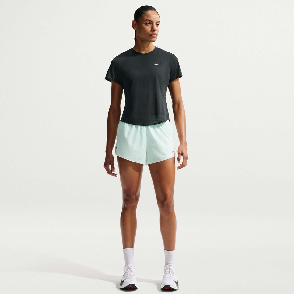 Front view of a model wearing the Nike Women's Swift Breathe Dri-FIT Short-Sleeve Running Top in the Black/Photon Dust/White/Reflective Silver colourway.