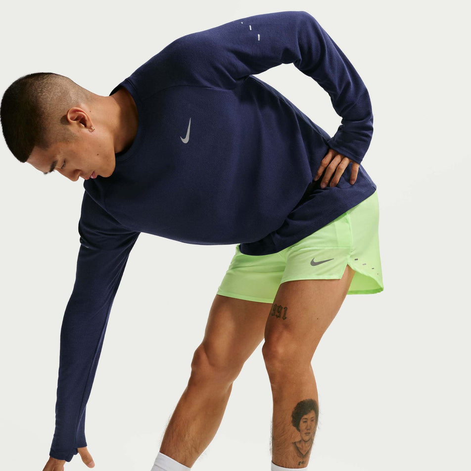 Angled view of a model wearing the Nike Men's Stride Dri-FIT 5