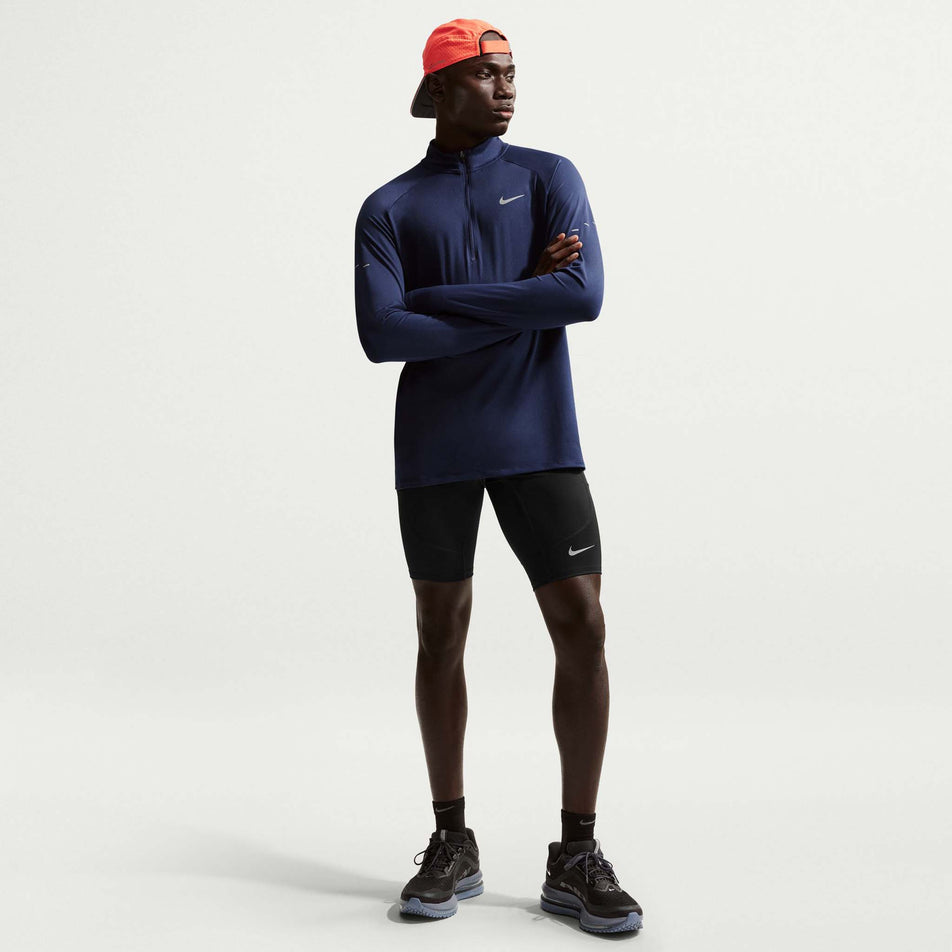 Front view of a model wearing the Nike Men's Stride Dri-FIT 1/2-Length Running Tights in the Black/Reflective Silver colourway.