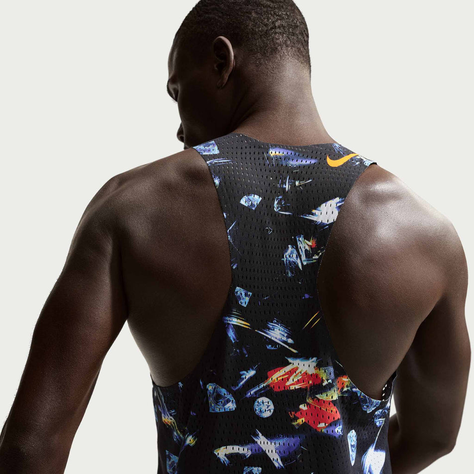 Back view of a model wearing the Nike Men's AeroSwift Dri-FIT ADV Running Singlet in the Black/Laser Orange colourway.