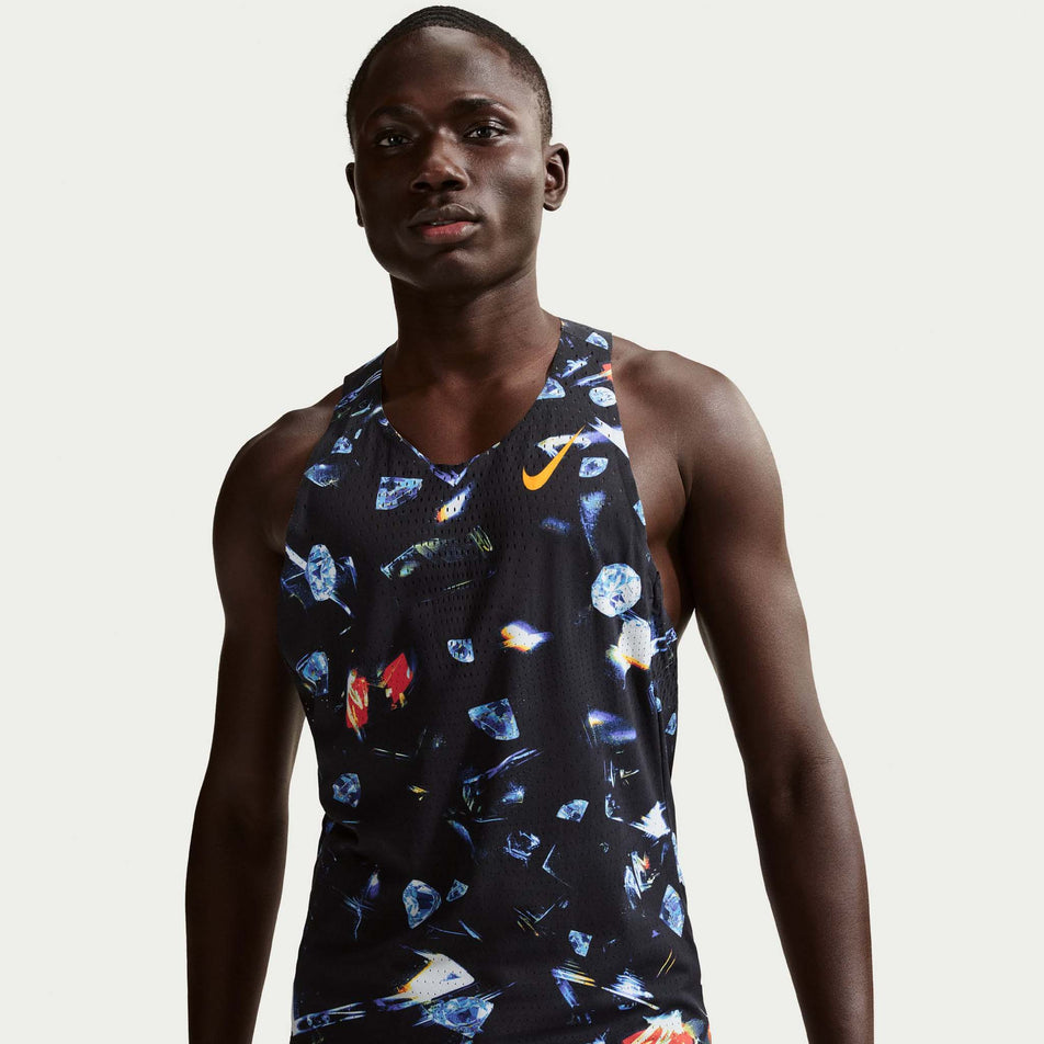 Front view of a model wearing the Nike Men's AeroSwift Dri-FIT ADV Running Singlet in the Black/Laser Orange colourway.