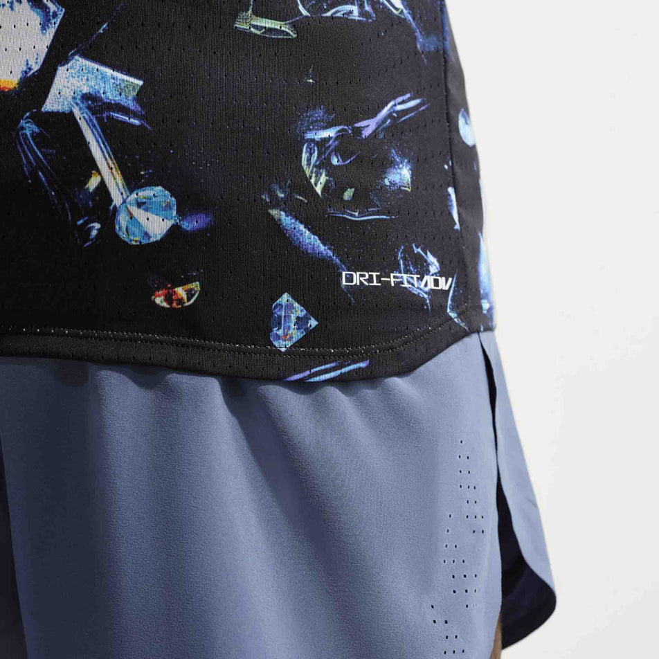 Close-up view of the Dri-FIT ADV branding on the Nike Men's AeroSwift Dri-FIT ADV Running Singlet in the Black/Laser Orange colourway.