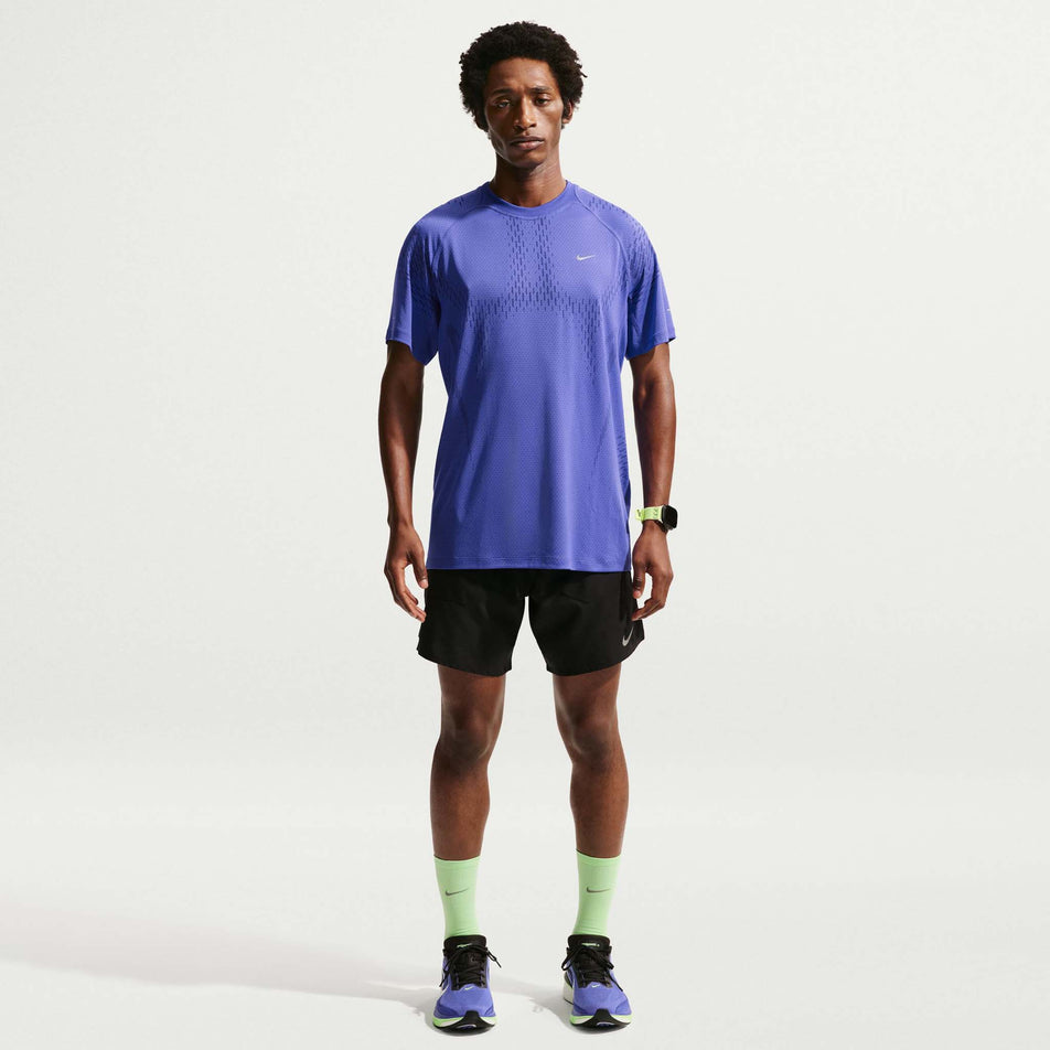 Front view of a model wearing the Nike Men's Stride Plus Dri-FIT ADV Short-Sleeve Running Top in the Lapis/Deep Royal Blue/Reflective Silver colourway.
