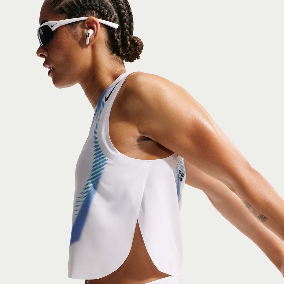 Side view of a model wearing the Nike Women's AeroSwift Dri-FIT ADV Cropped Running Tank Top in the White/Black/Black colourway.