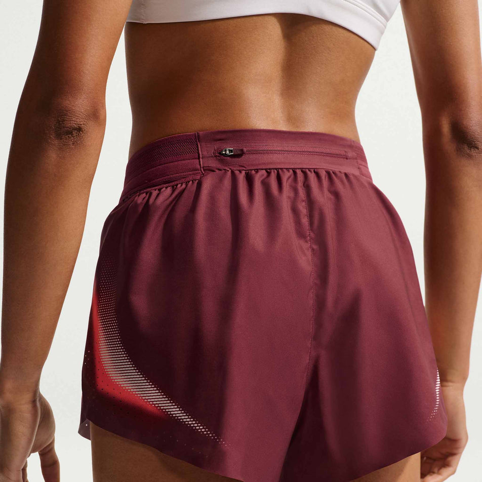 Back view of a model wearing the Nike Women's AeroSwift Dri-FIT ADV Brief-Lined 3