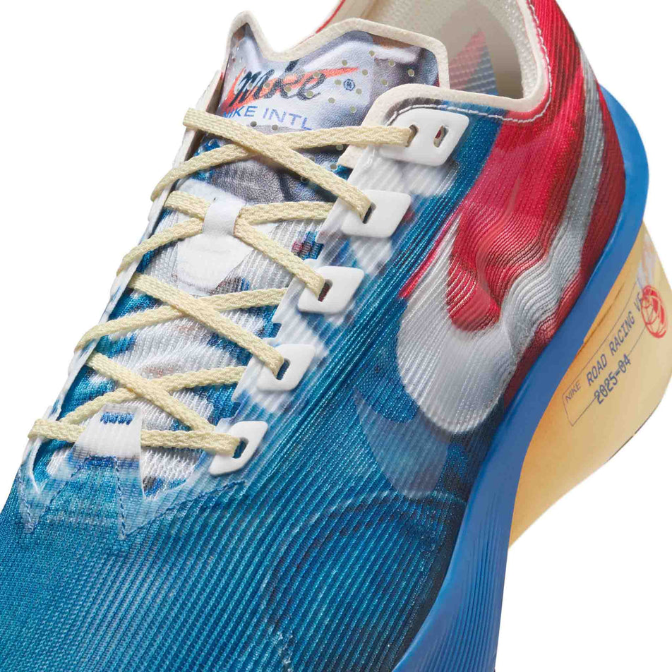 Close-up view of the upper of the left shoe from a pair of Nike Men's Vaporfly 4 Premium Road Racing Shoes in the Multi-Color/Clear-Mountain Blue-Fire Red colourway. (8723630260386)