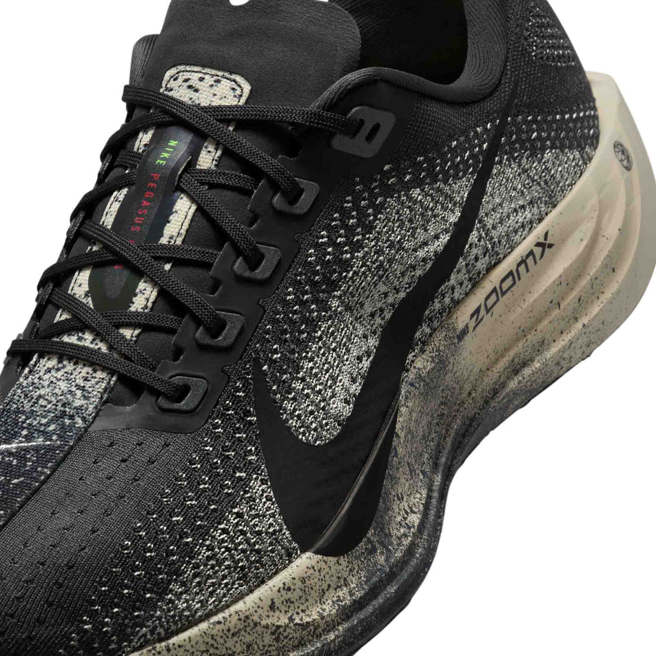 Close up of the upper of the left shoe from a pair of Nike Men's Pegasus Plus Road Running Shoes in the Oatmeal/Black-Anthracite-Volt colourway. (8683765563554)