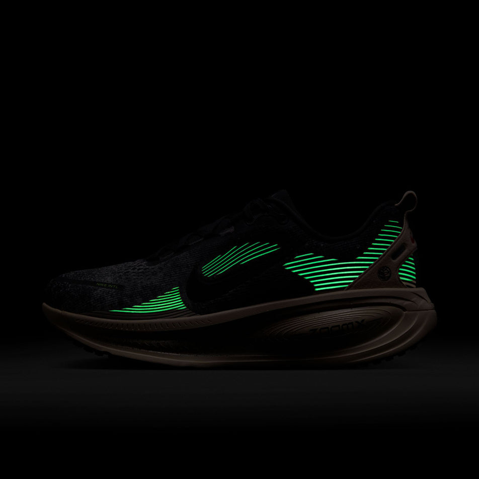 The reflective graphics on the lateral side of the left shoe from a pair of Nike Men's Vomero 18 Road Running Shoes in the Oatmeal/Black-Anthracite-Volt colourway.(8684581552290)