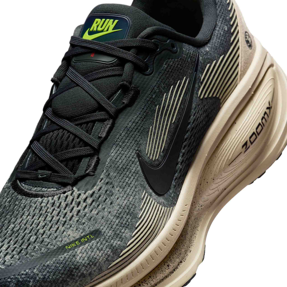 Close-up view of the upper of the left shoe from a pair of Nike Men's Vomero 18 Road Running Shoes in the Oatmeal/Black-Anthracite-Volt colourway. (8684581552290)