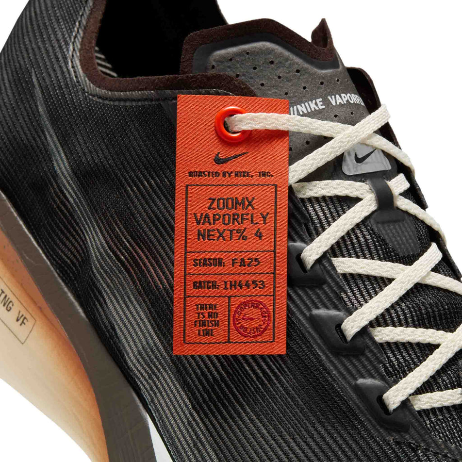 Close-up view of the special tag that comes with the Nike Men's Vaporfly 4 Road Racing Shoes in the Velvet Brown/Soft Pearl-Black colourway. (8723634094242)