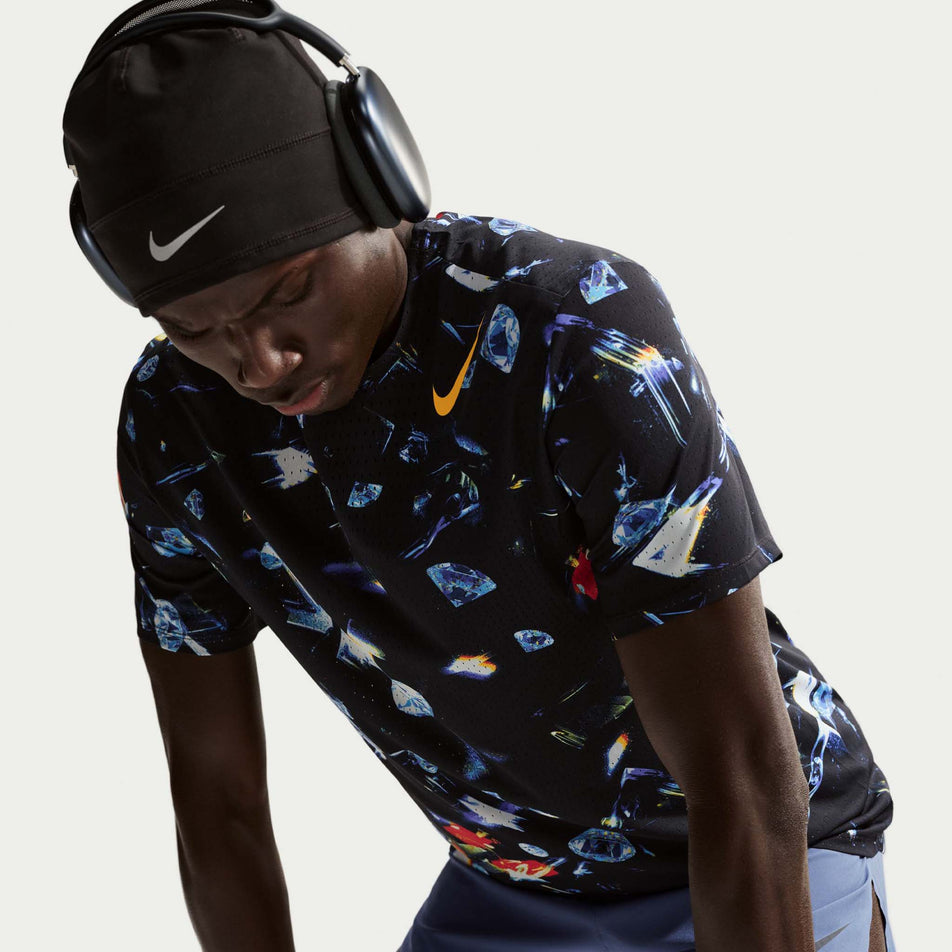 Front view of a model wearing the Nike Men's AeroSwift Dri-FIT ADV Short-Sleeve Running Top in the Black/Laser Orange colourway.