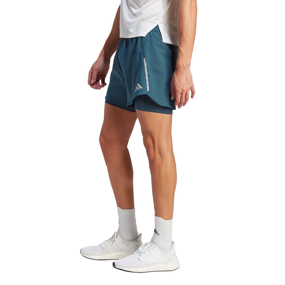 Side view of a model wearing a pair of adidas Men's Designed 4 Running 2-in-1 Shorts in the Arctic Night colourway (8005321064610)